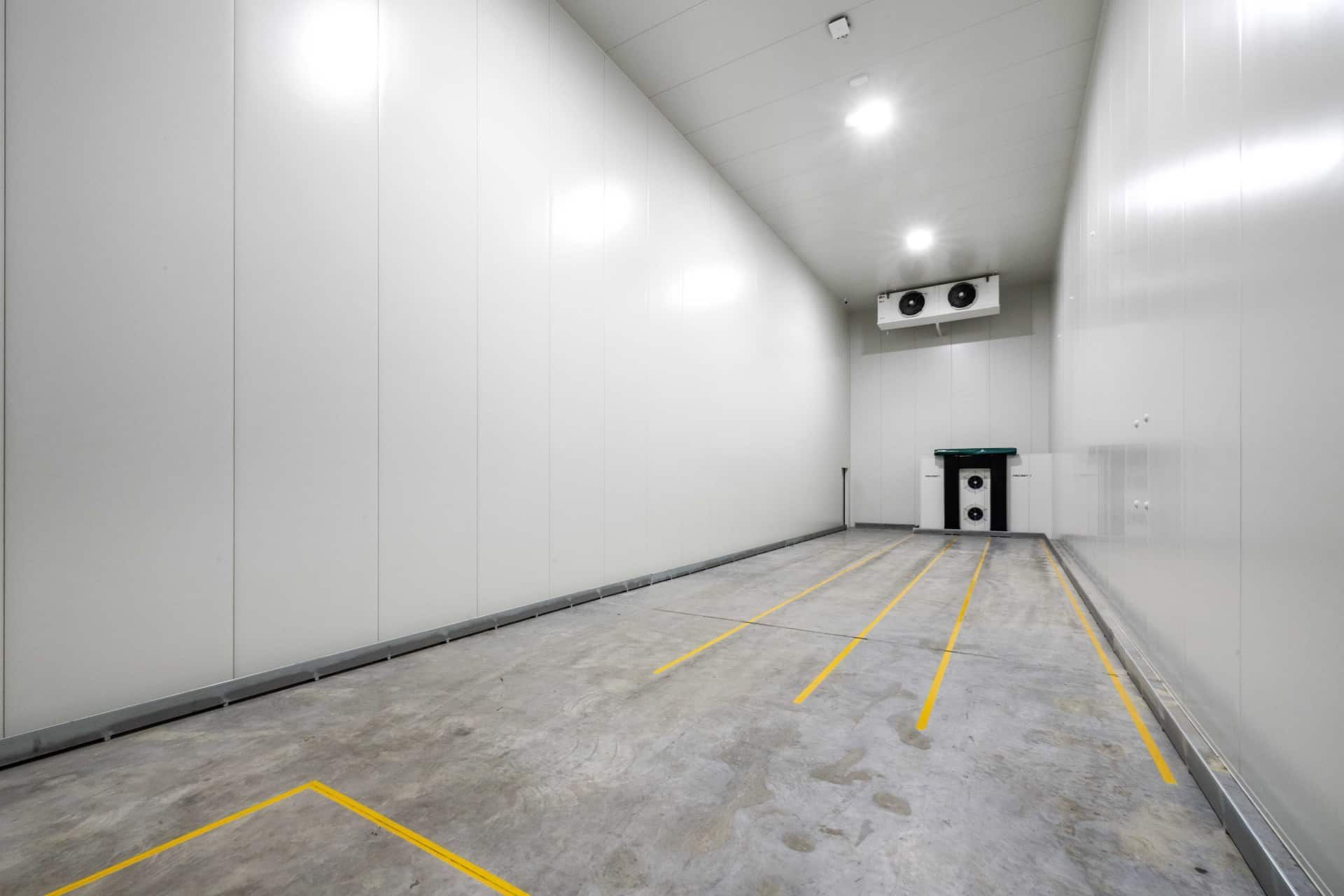 A Large Empty Room With White Walls and Yellow Lines on the Floor — Refrigerated Technologies (QLD) Pty Ltd In Bowen, QLD