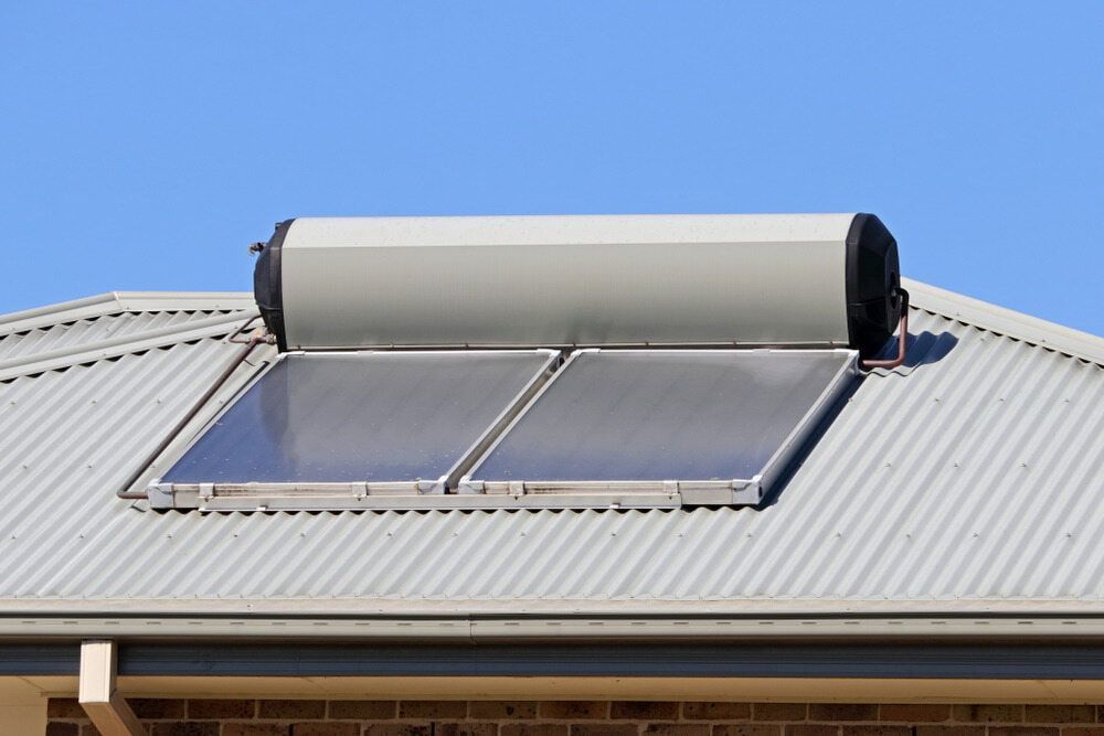 A Solar Water Heater is Mounted on the Roof of a House — Refrigerated Technologies (QLD) Pty Ltd In Bowen, QLD