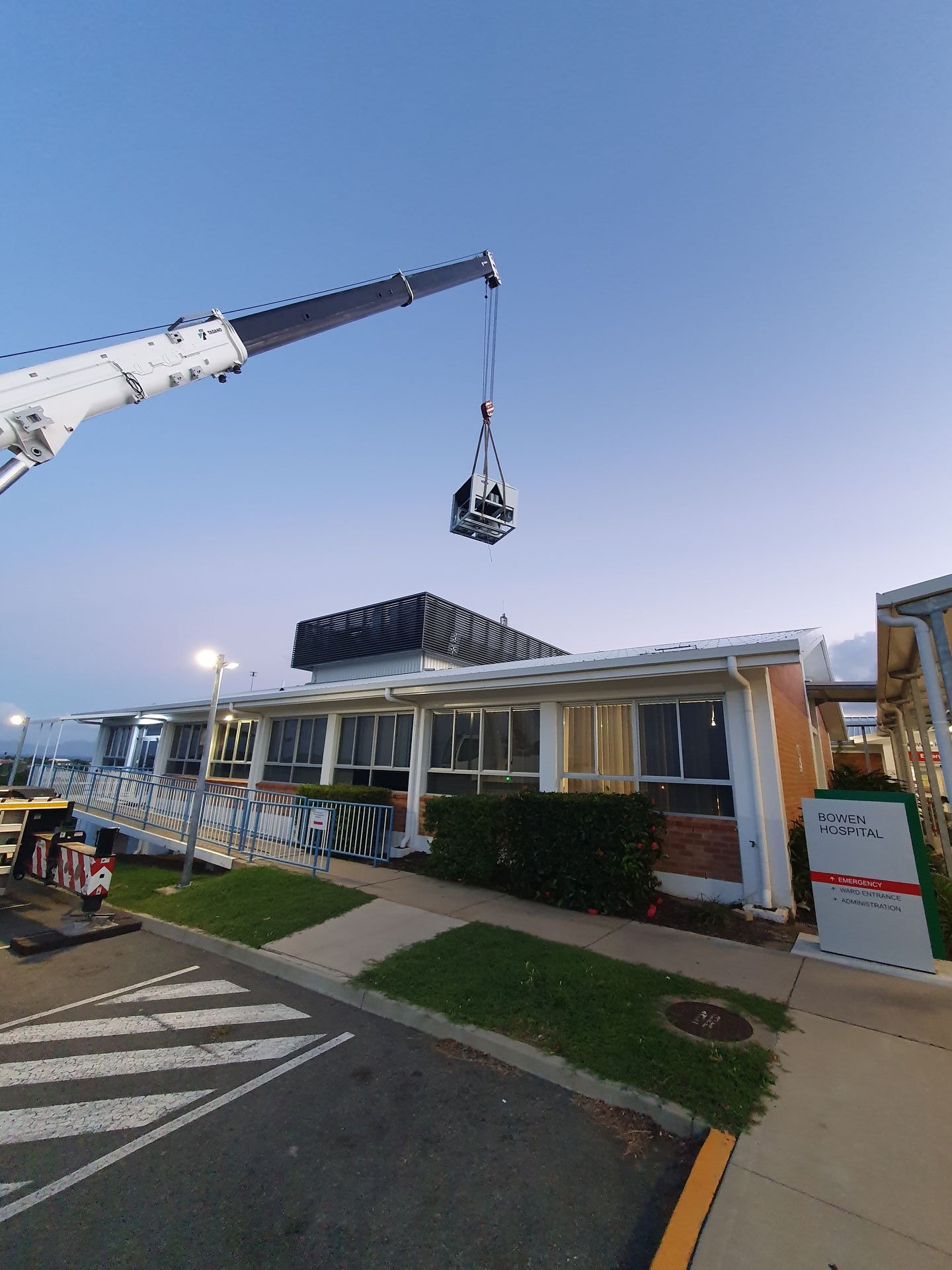 A Crane is Lifting a Roof of a Building — Refrigerated Technologies (QLD) Pty Ltd In Bowen, QLD