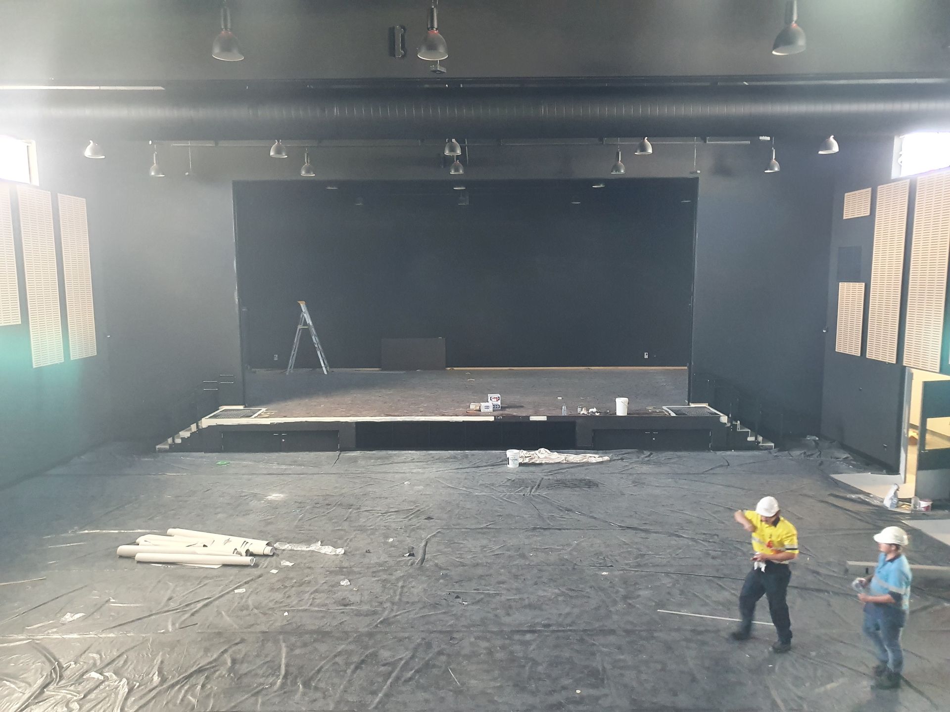 Two Men Are Standing in Front of an Empty Stage — Refrigerated Technologies (QLD) Pty Ltd In Bowen, QLD