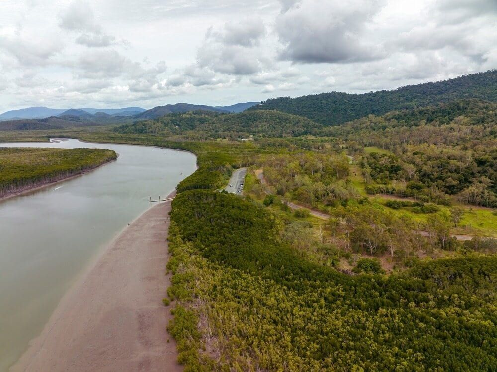 An Aerial View of a River Surrounded by Trees and Mountains — Refrigerated Technologies (QLD) Pty Ltd In Proserpine, QLD