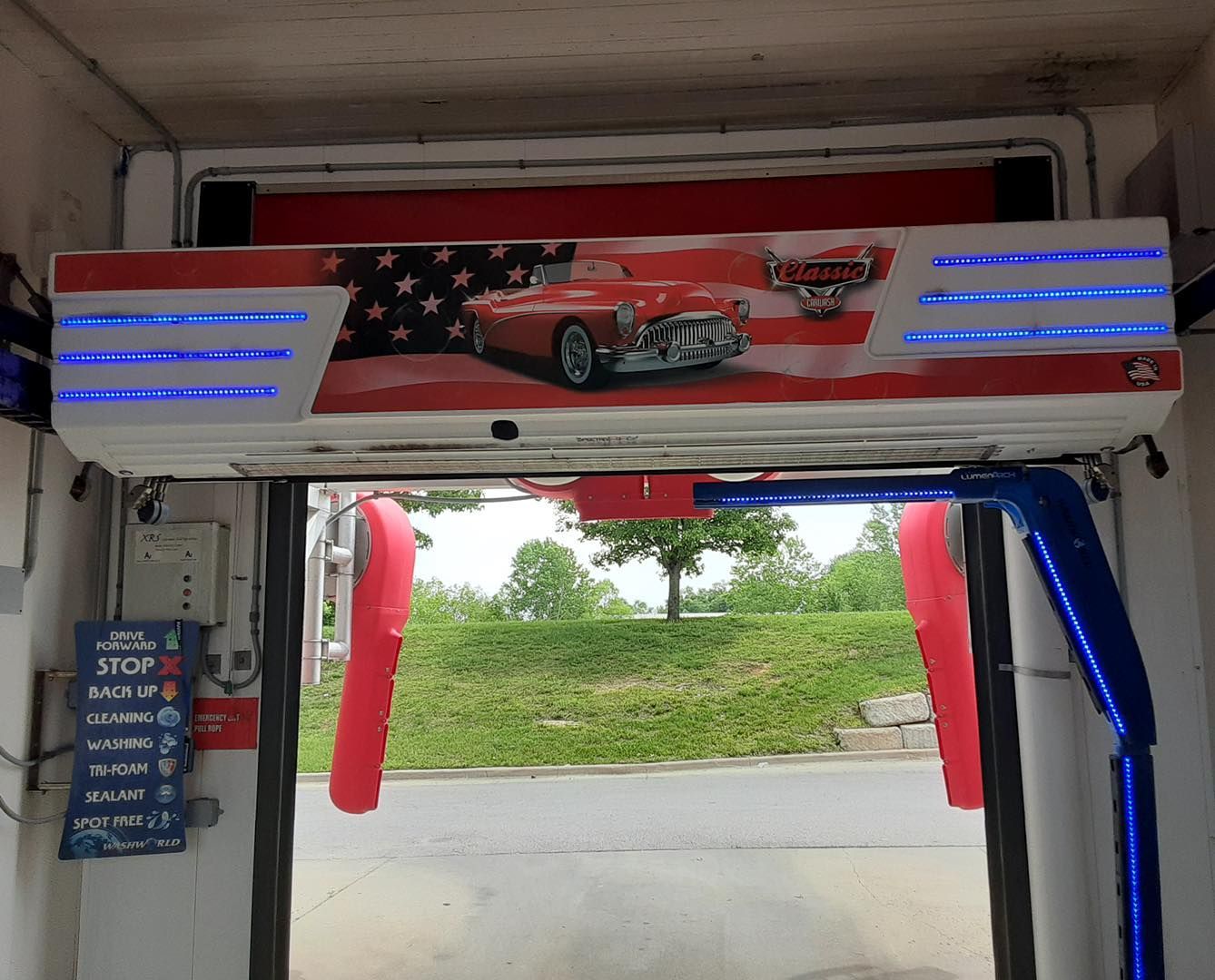 A car wash with a sign that says stop on it