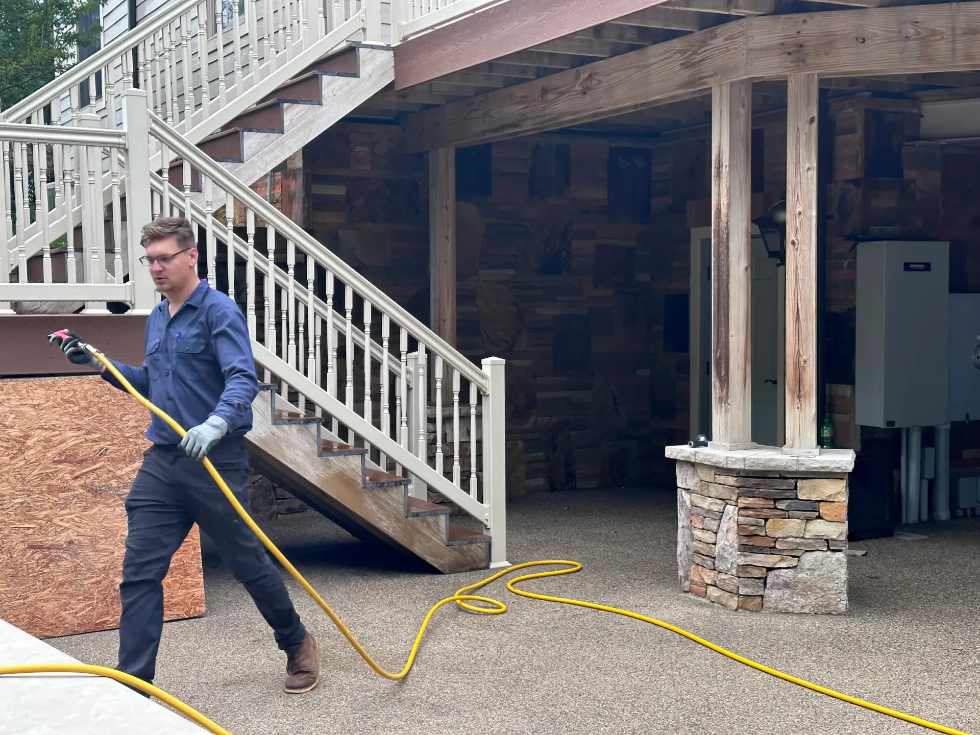 A close-up of a technician sealing rodent entry points around a home.