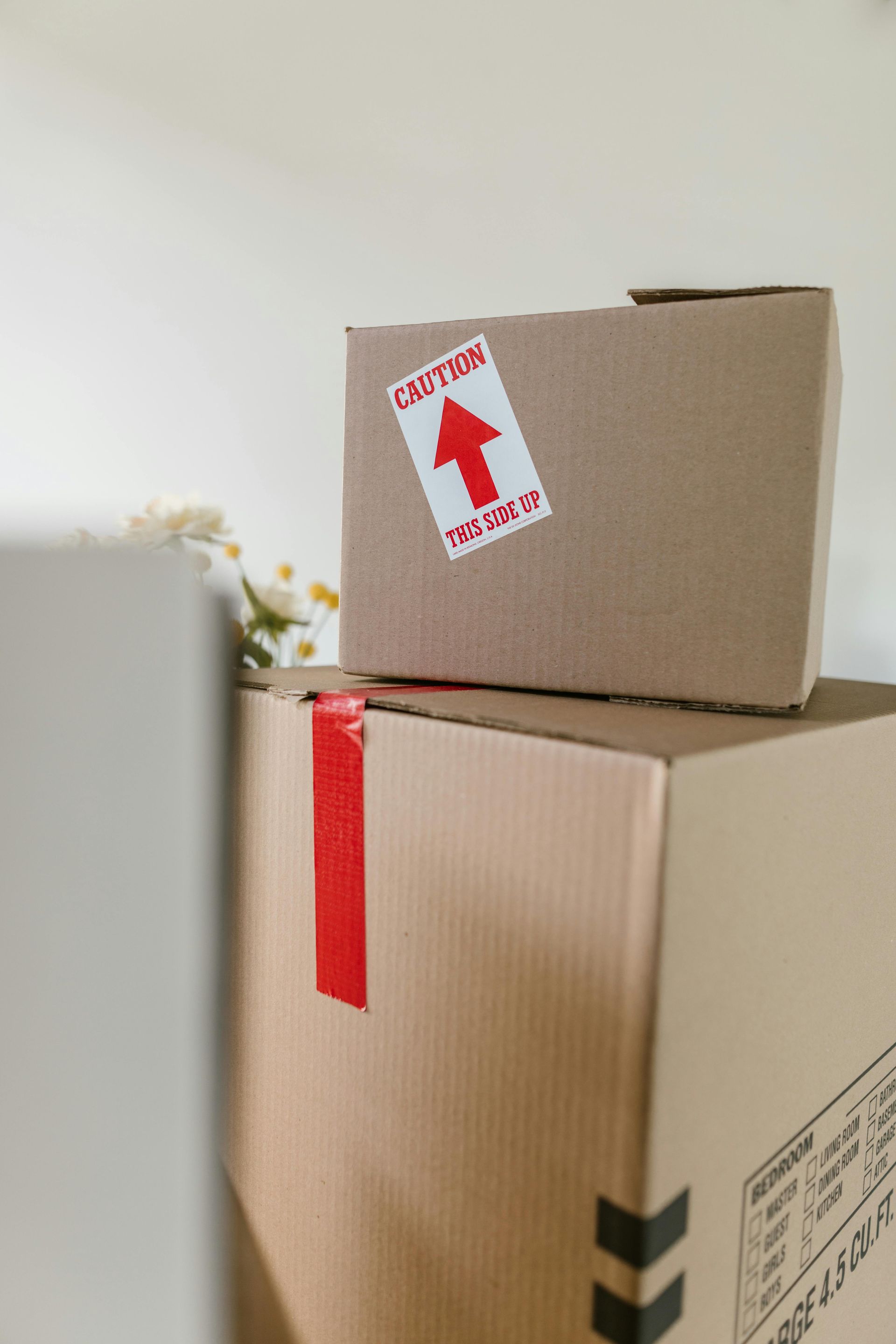 Cardboard boxes stacked, one marked
