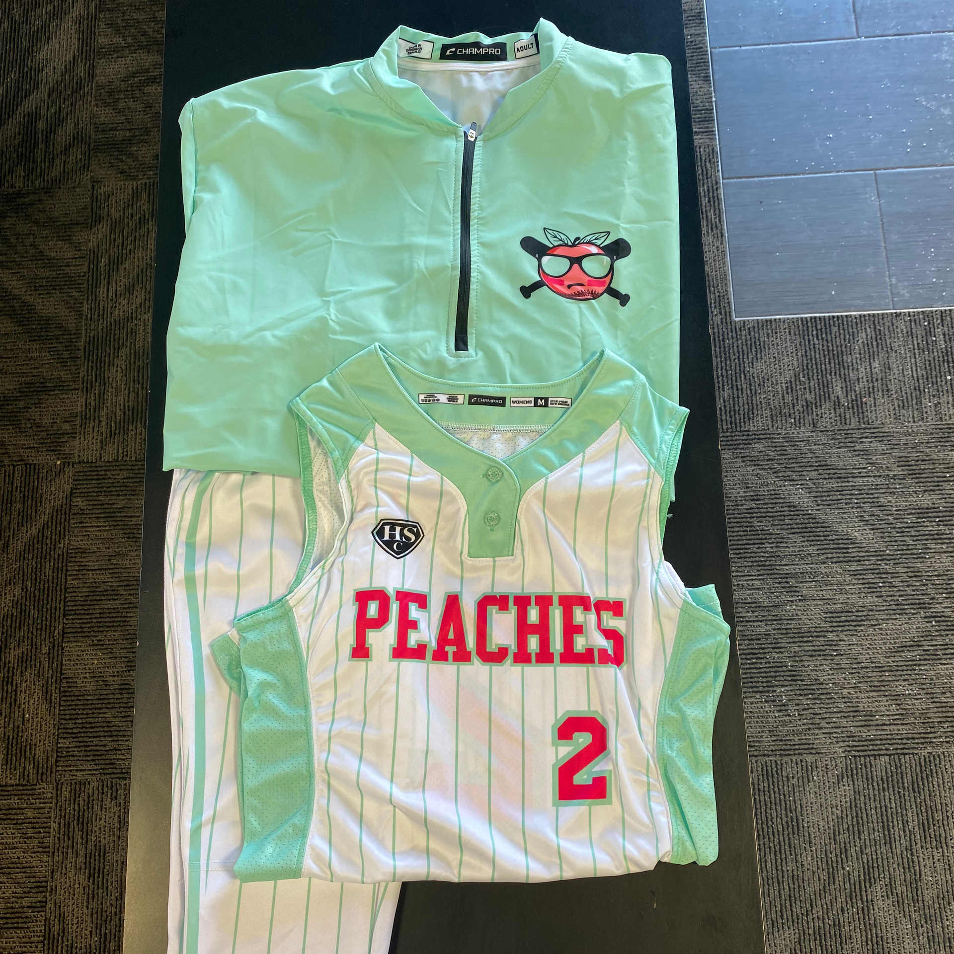 Softball uniform, mint green and white. Jersey and pants with