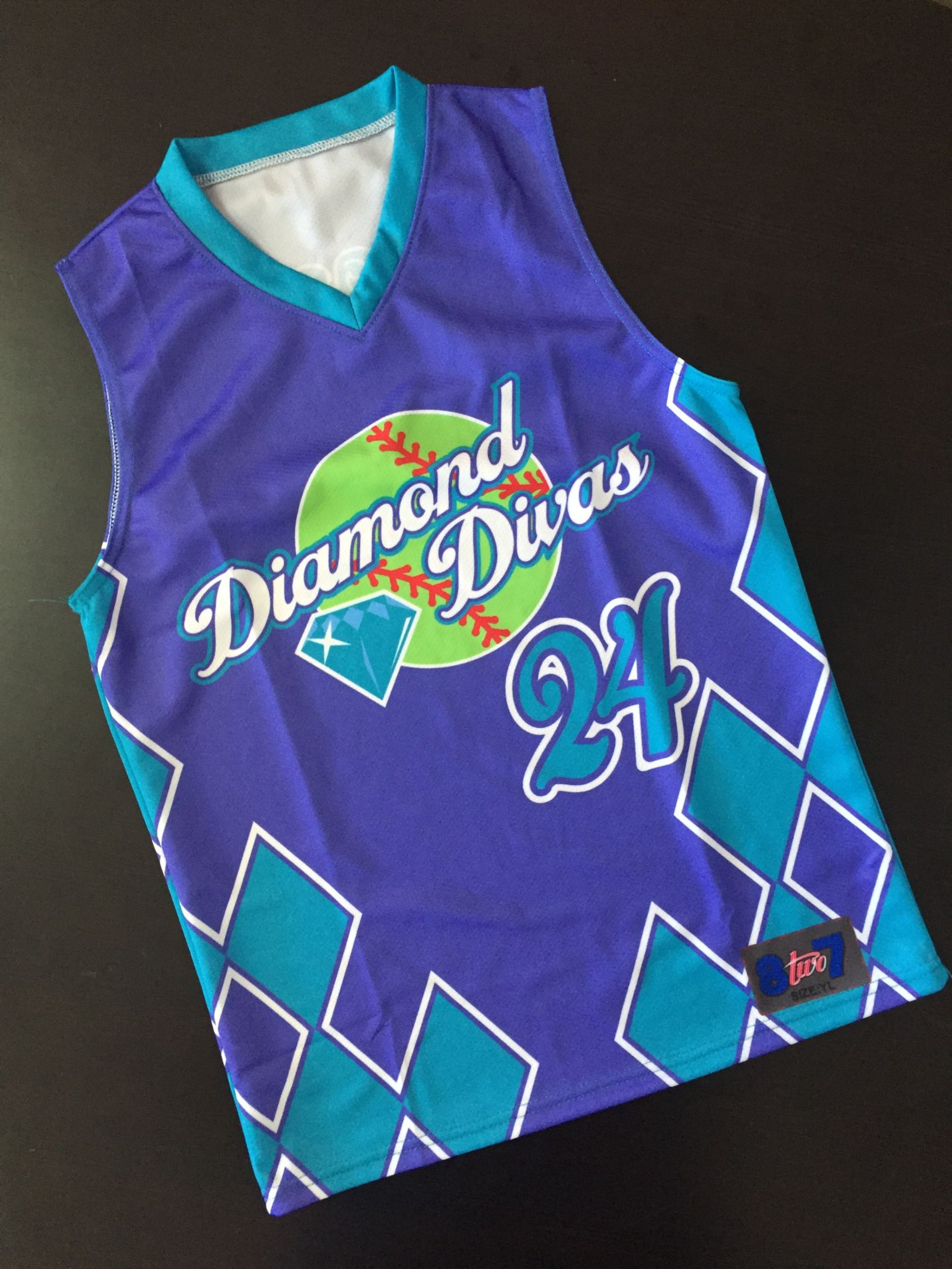 Purple and teal Diamond Divas softball jersey with number 24 and team logo.