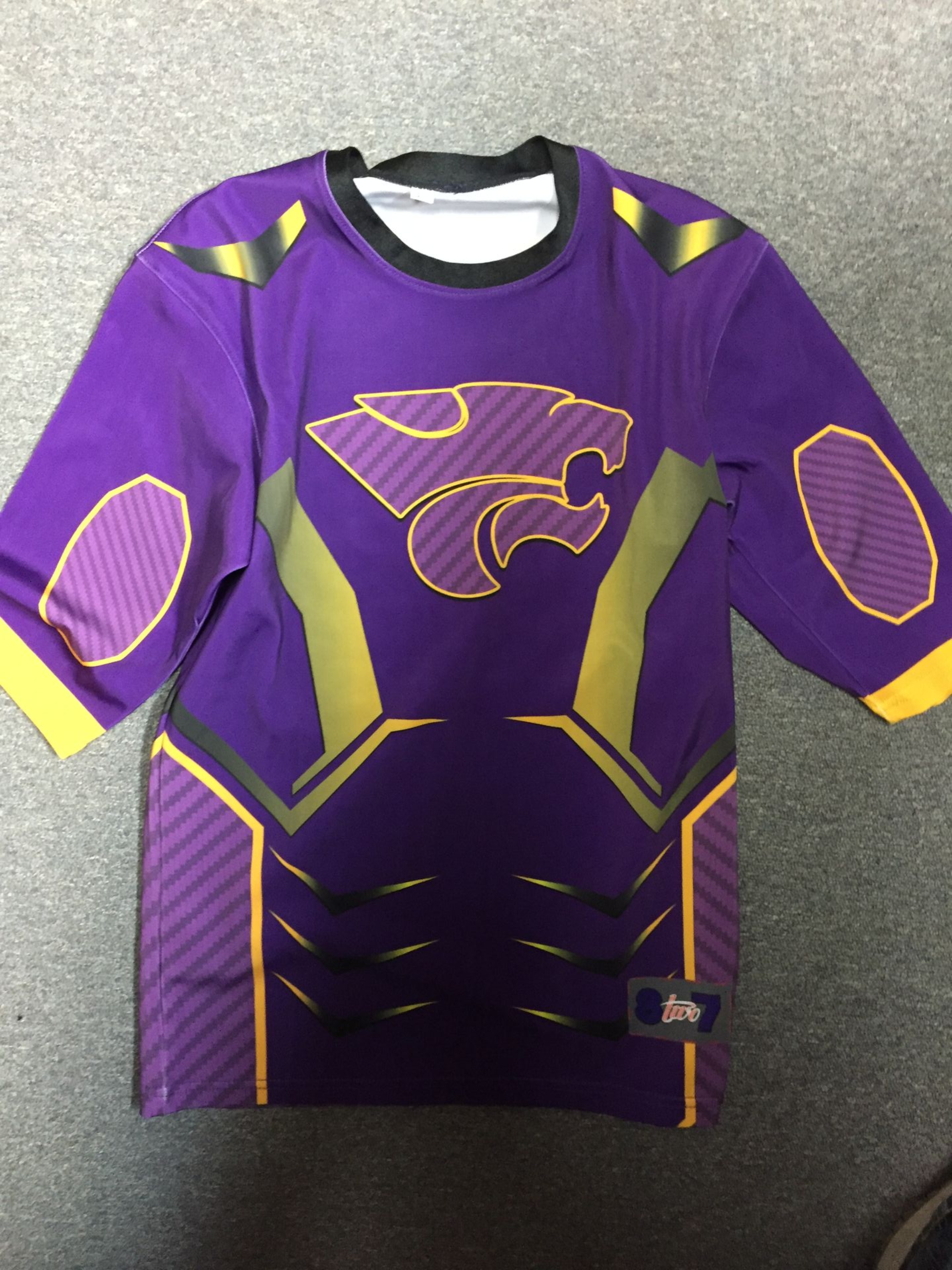 Purple and gold jersey with a cougar logo.