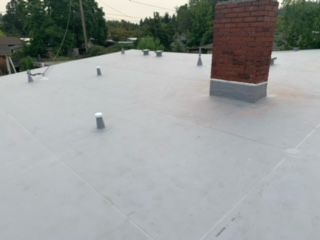 A roof featuring a chimney atop it - Springfield, OR - McKenzie Roofing Inc.