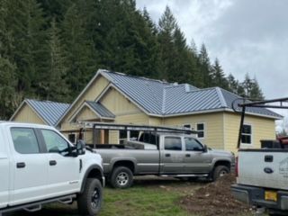 A truck parked in front of a house - Springfield, OR - McKenzie Roofing Inc.