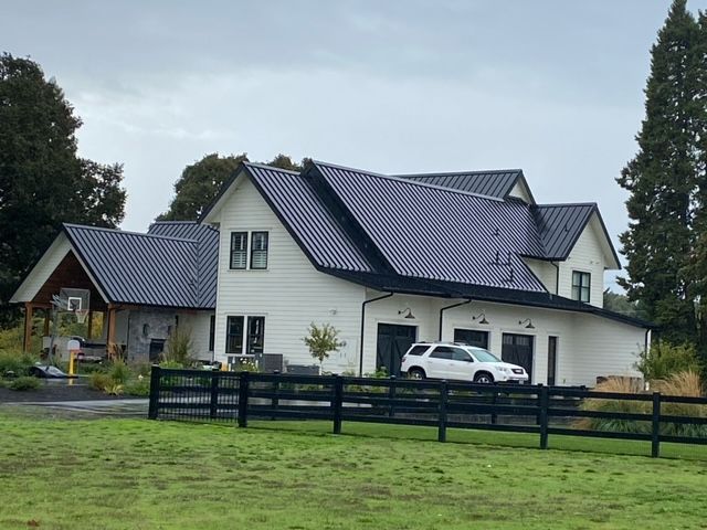 A house with a black roof and white siding - Springfield, OR - McKenzie Roofing Inc.