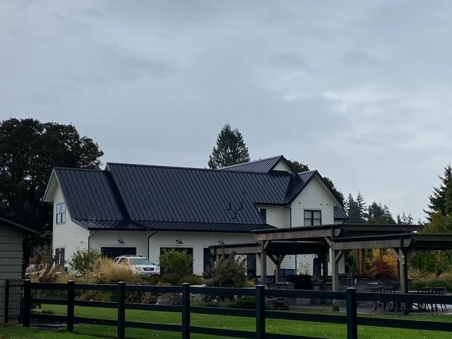 Spacious house with black roof and fence - Springfield, OR - McKenzie Roofing Inc.