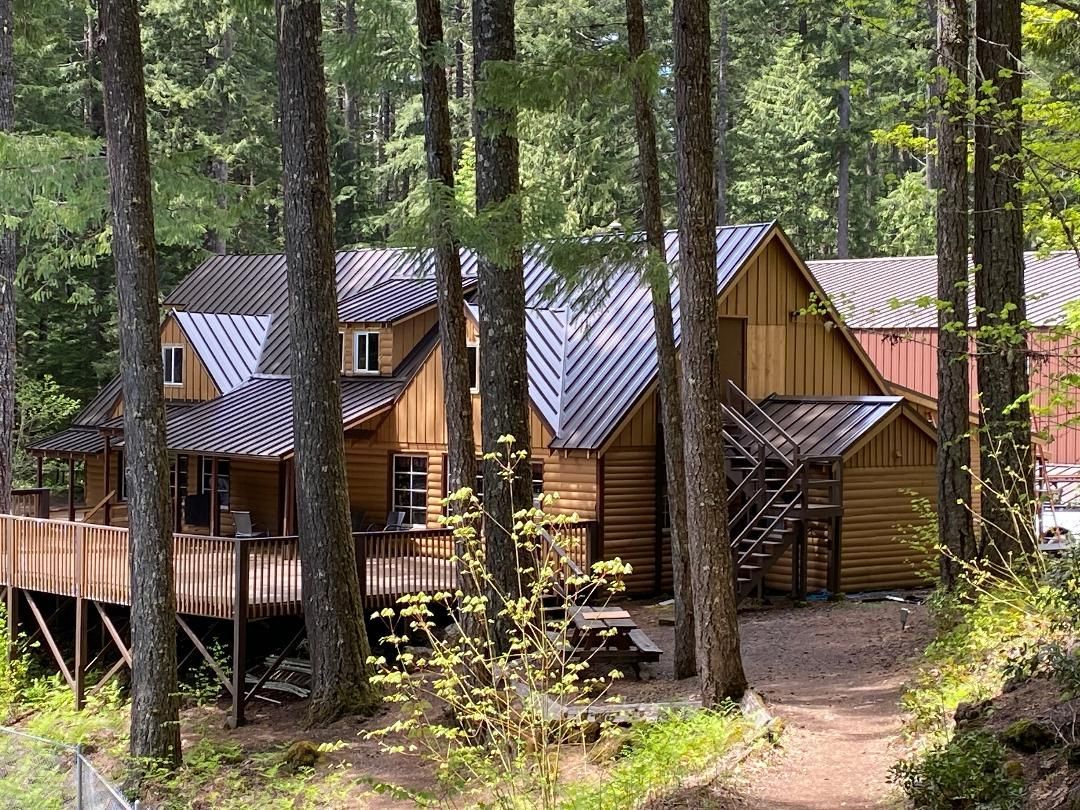 A cabin situated in a tranquil wooded area - Springfield, OR - McKenzie Roofing Inc.