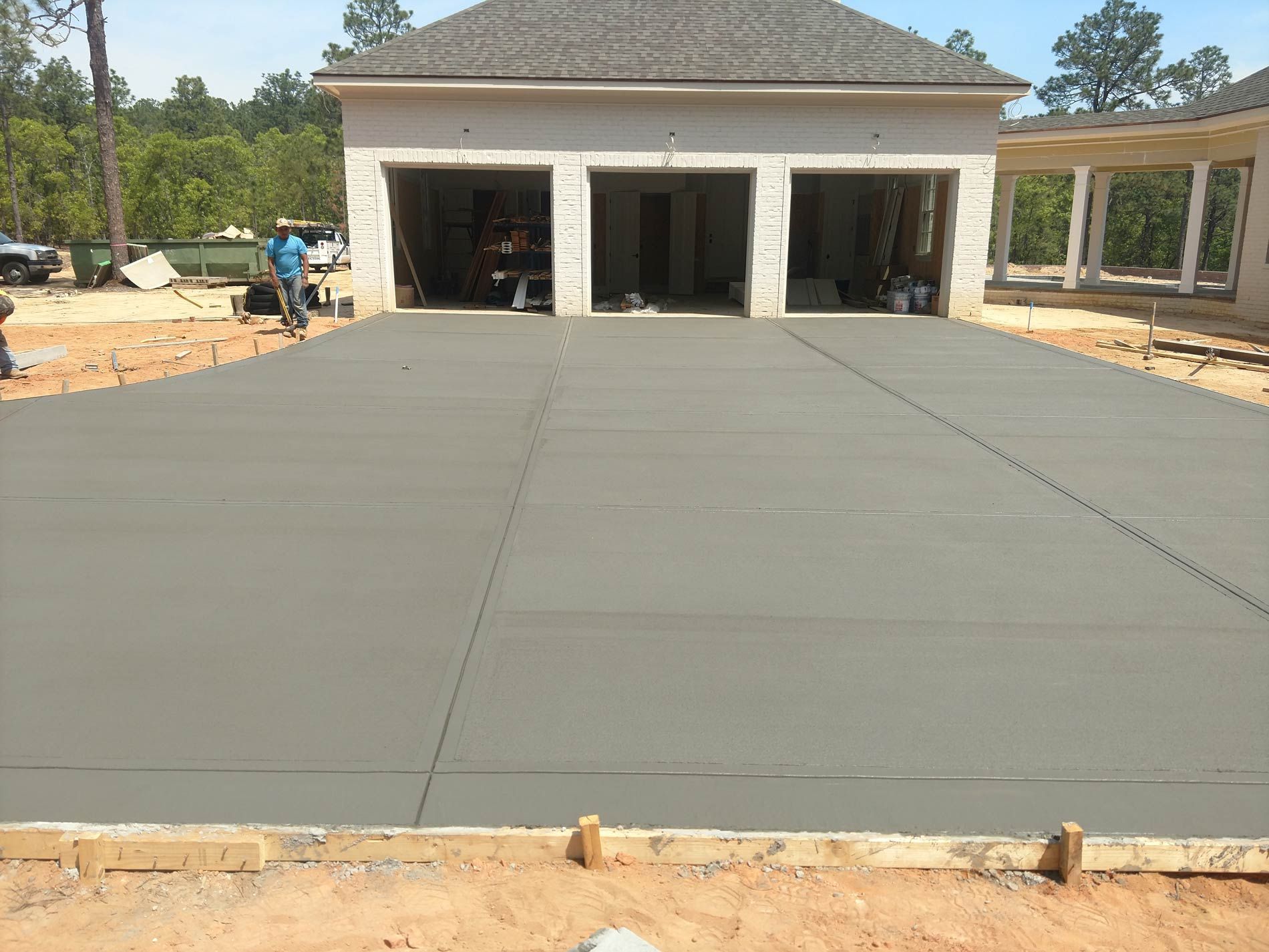 Concrete pool deck surrounding a rectangular pool filled with water, in a backyard setting. Concrete pool deck surrounding a rectangular pool filled with water, in a backyard setting.