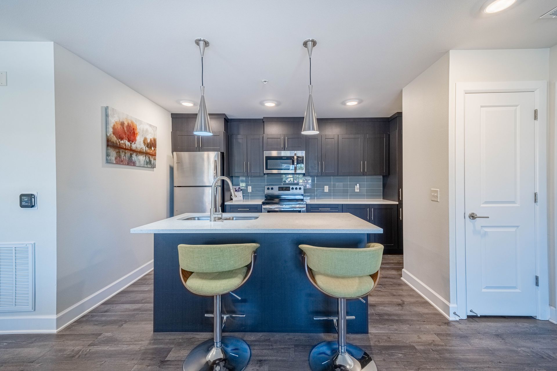 a kitchen with stainless steel appliances and black cabinets
