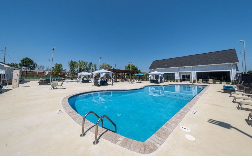 outdoor community pool area at watercolors of centerton apartments