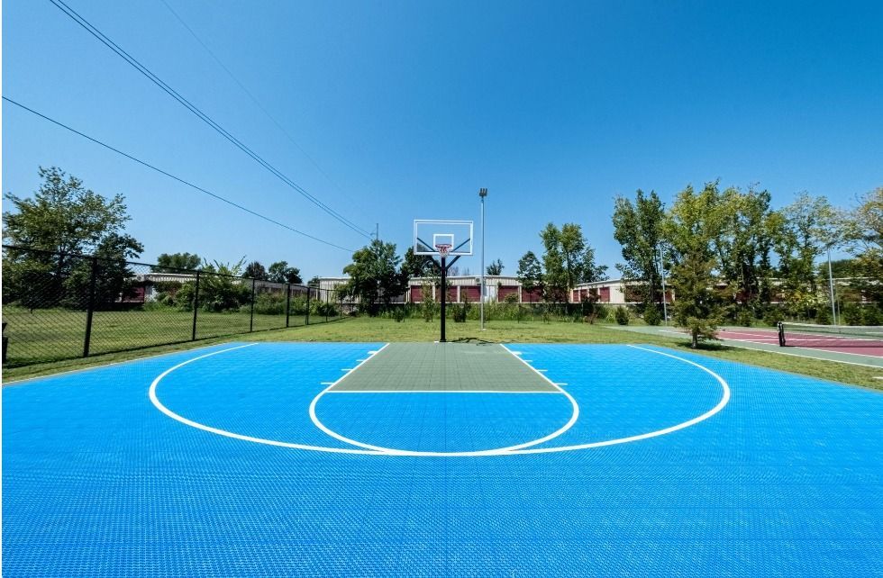 outdoor basketball court 
at watercolors of centerton apartments