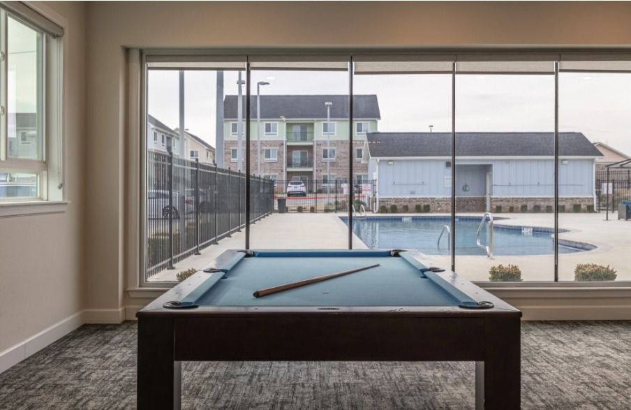 billiards table inside the game room at watercolors of centerton apartments
