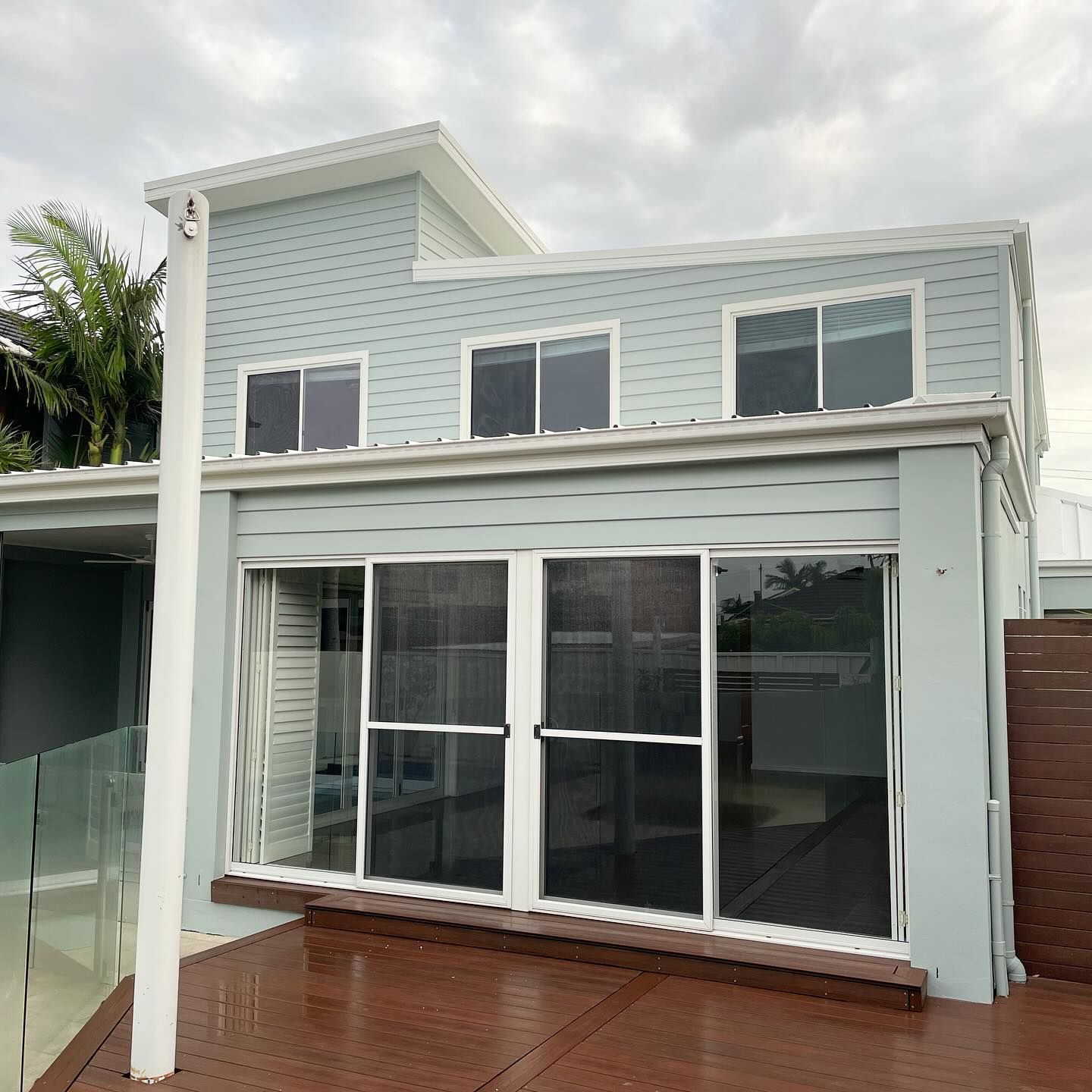 A Large White House With a Swimming Pool in the Backyard — D & J Saverino Painting & Decorating Pty Ltd In Fairy Meadow, NSW