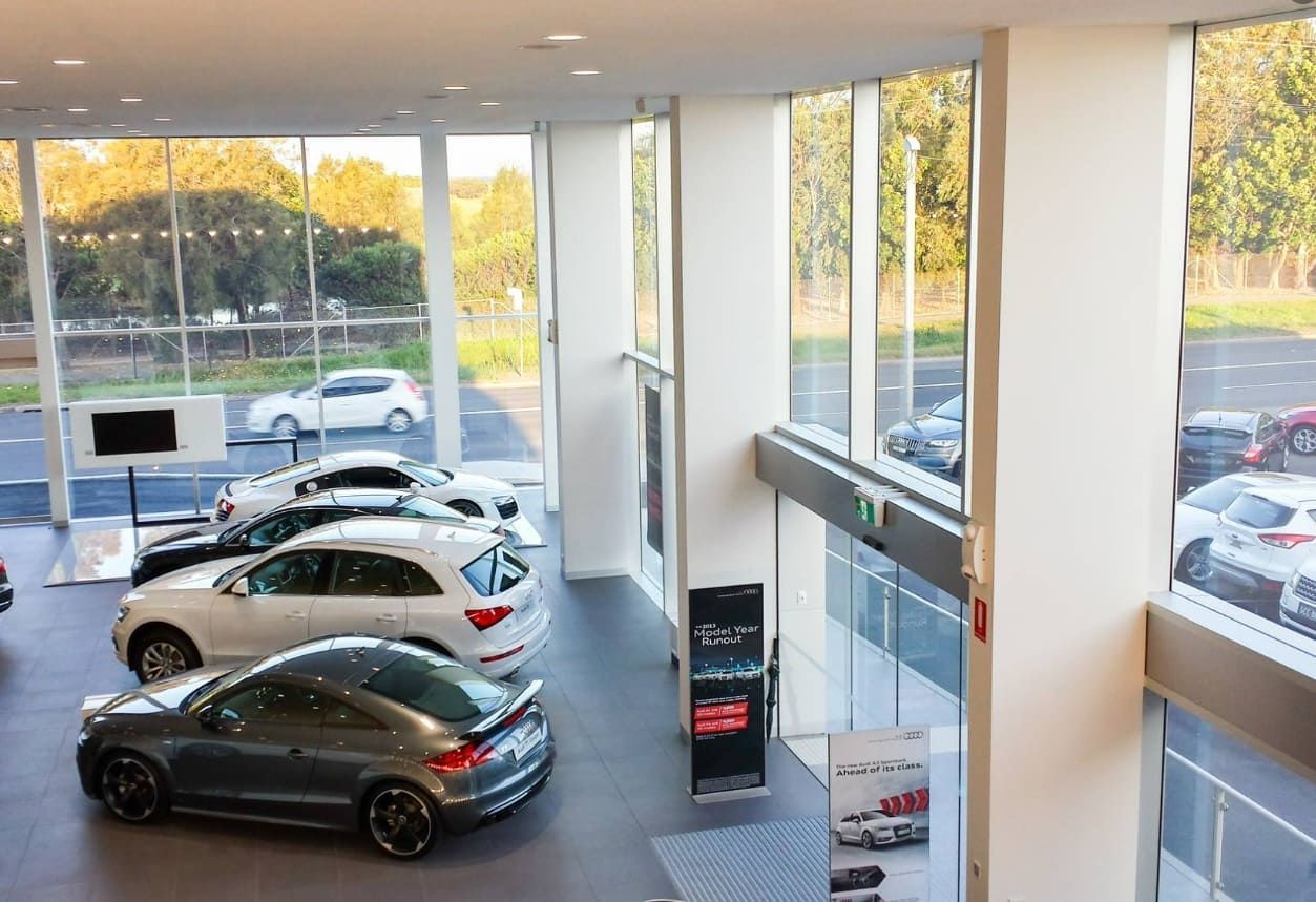 A Car Dealership With a Lot of Cars on Display — D & J Saverino Painting & Decorating Pty Ltd In Fairy Meadow, NSW