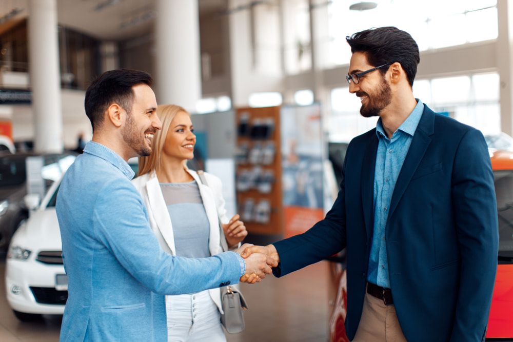 People Are Shaking Hands in a Car Showroom — Duffys Car Rentals in Chillagoe, QLD