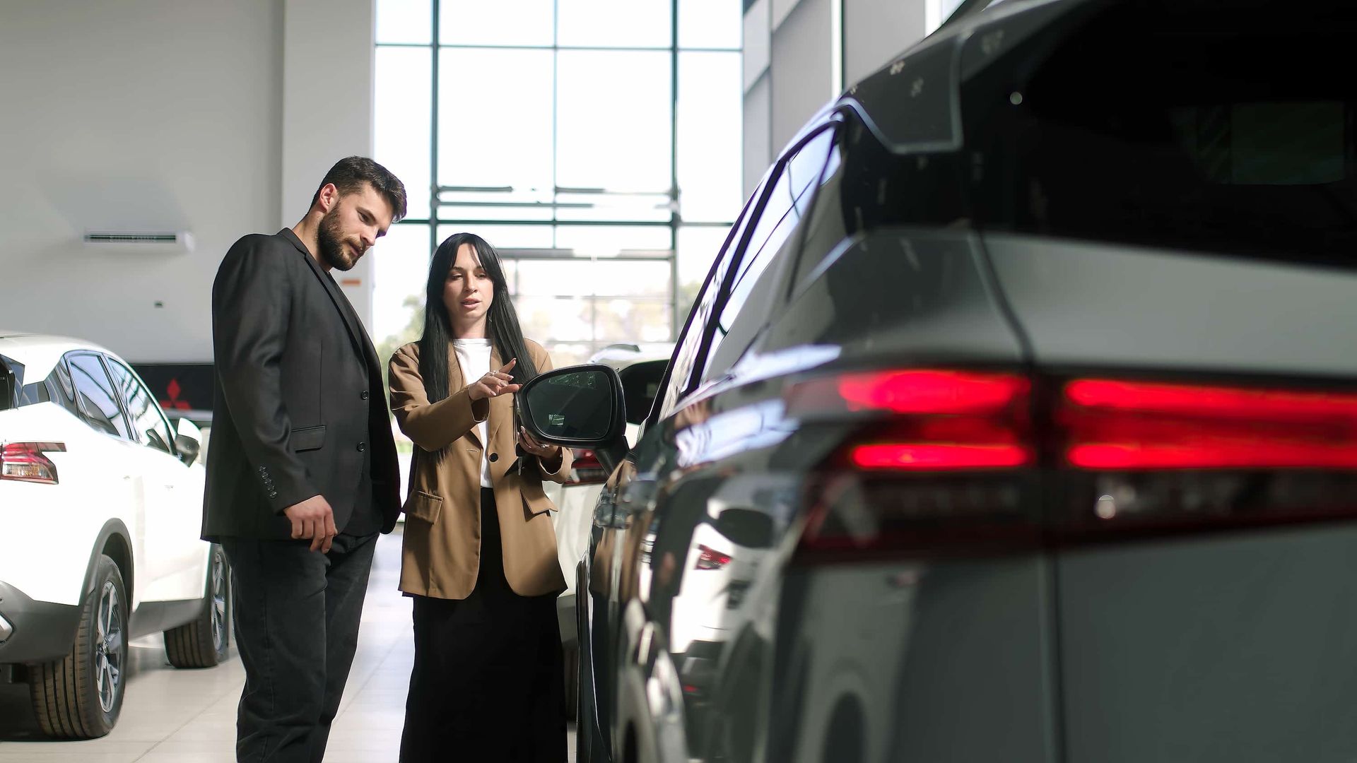 A Man and a Woman Are Looking at a Car ā Duffys Car Rentals in Atherton, QLD