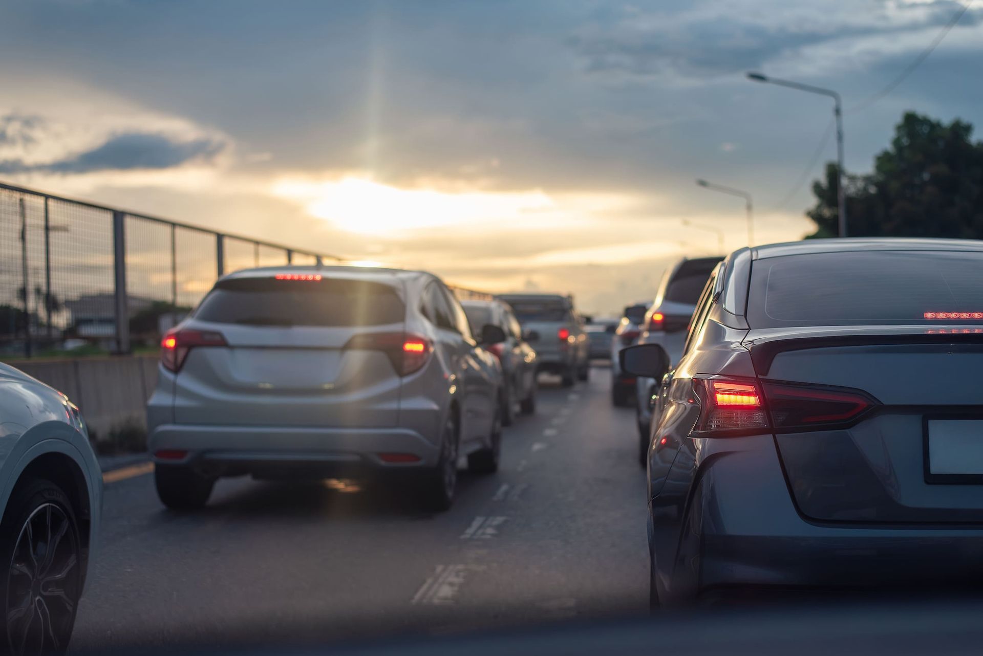 A Row of Cars Are Driving Down a Highway at Sunset ā Duffys Car Rentals in Ravenshoe, QLD