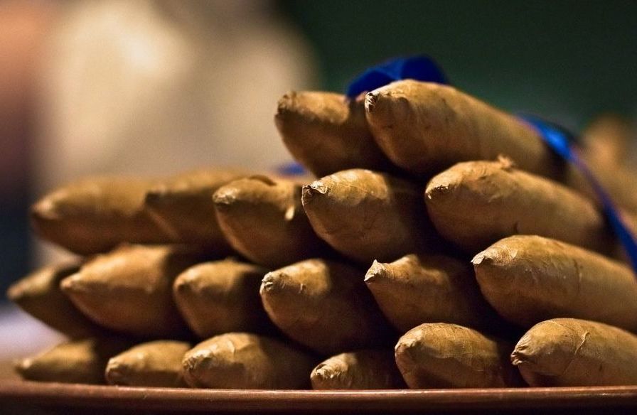 a stack of sticks on a plate with a blue ribbon around them