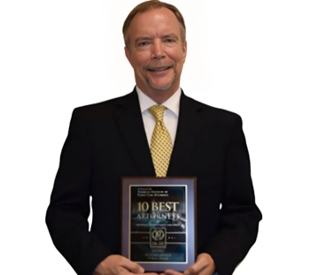A man in a suit and tie is holding a 10 best award