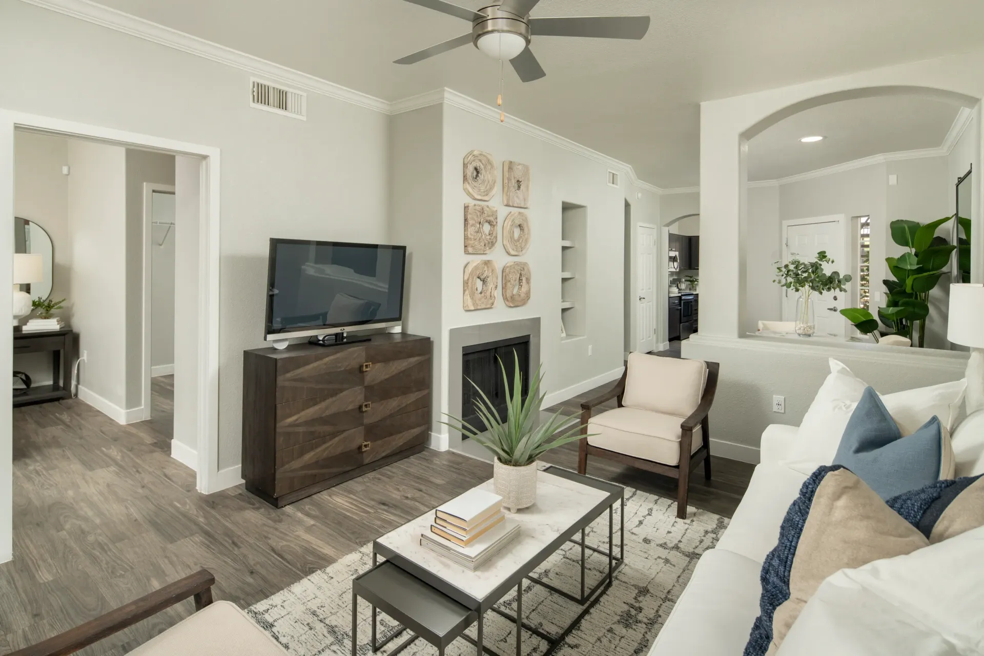 Living room with a TV, fireplace, and seating area at Pinnacle Heights in Tucson, AZ.