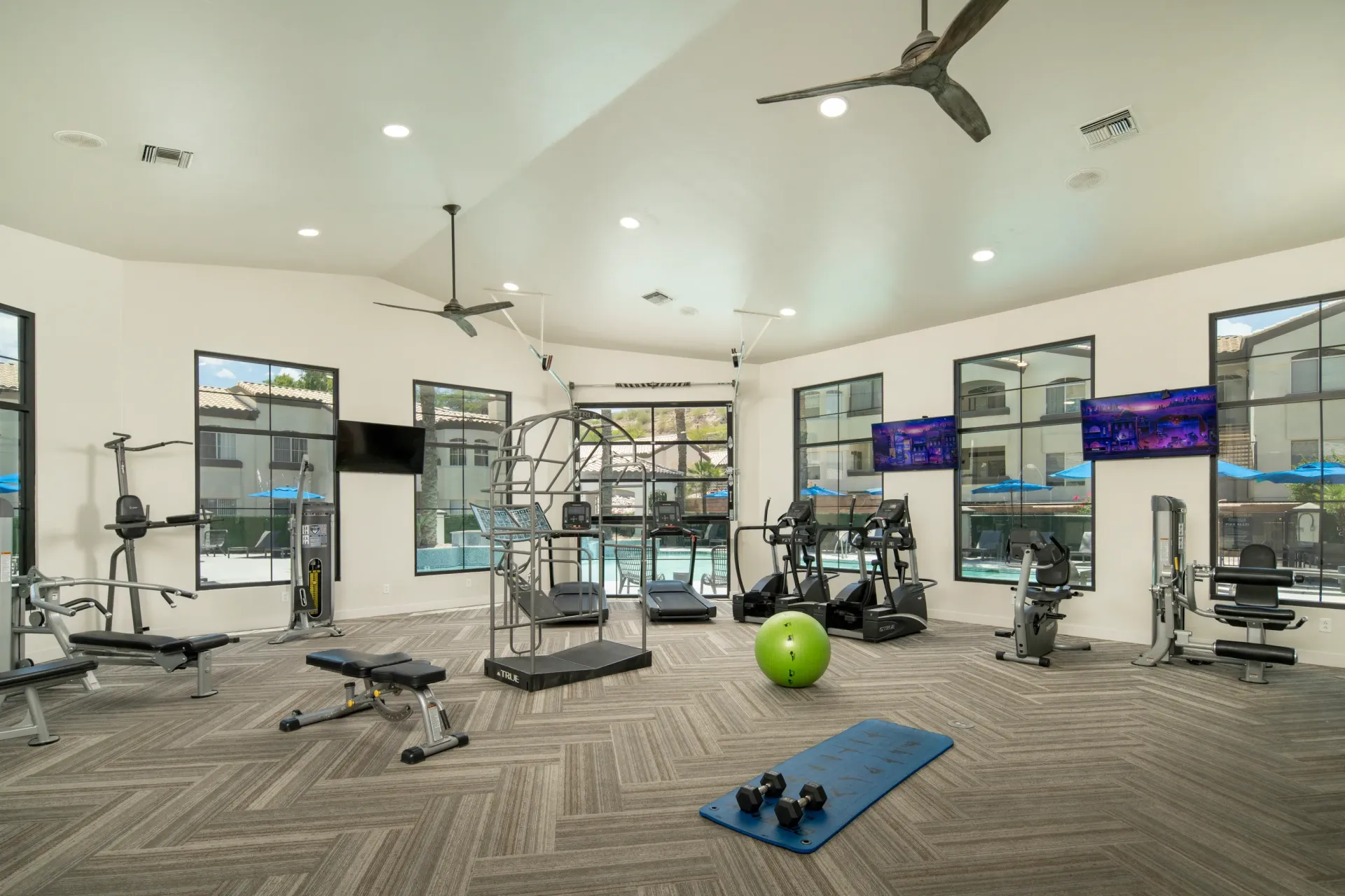 Fitness center with cardio machines, weight machines, and free weights.