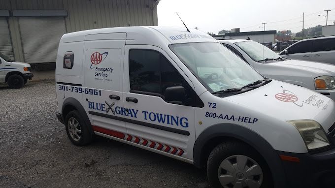 A white van with the word towing on it
