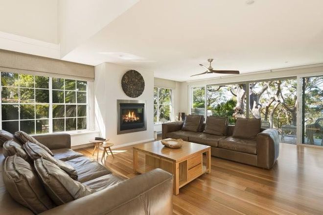 A living room filled with furniture and a fireplace.