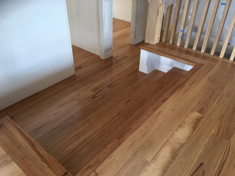 A wooden staircase with a wooden railing in a house.