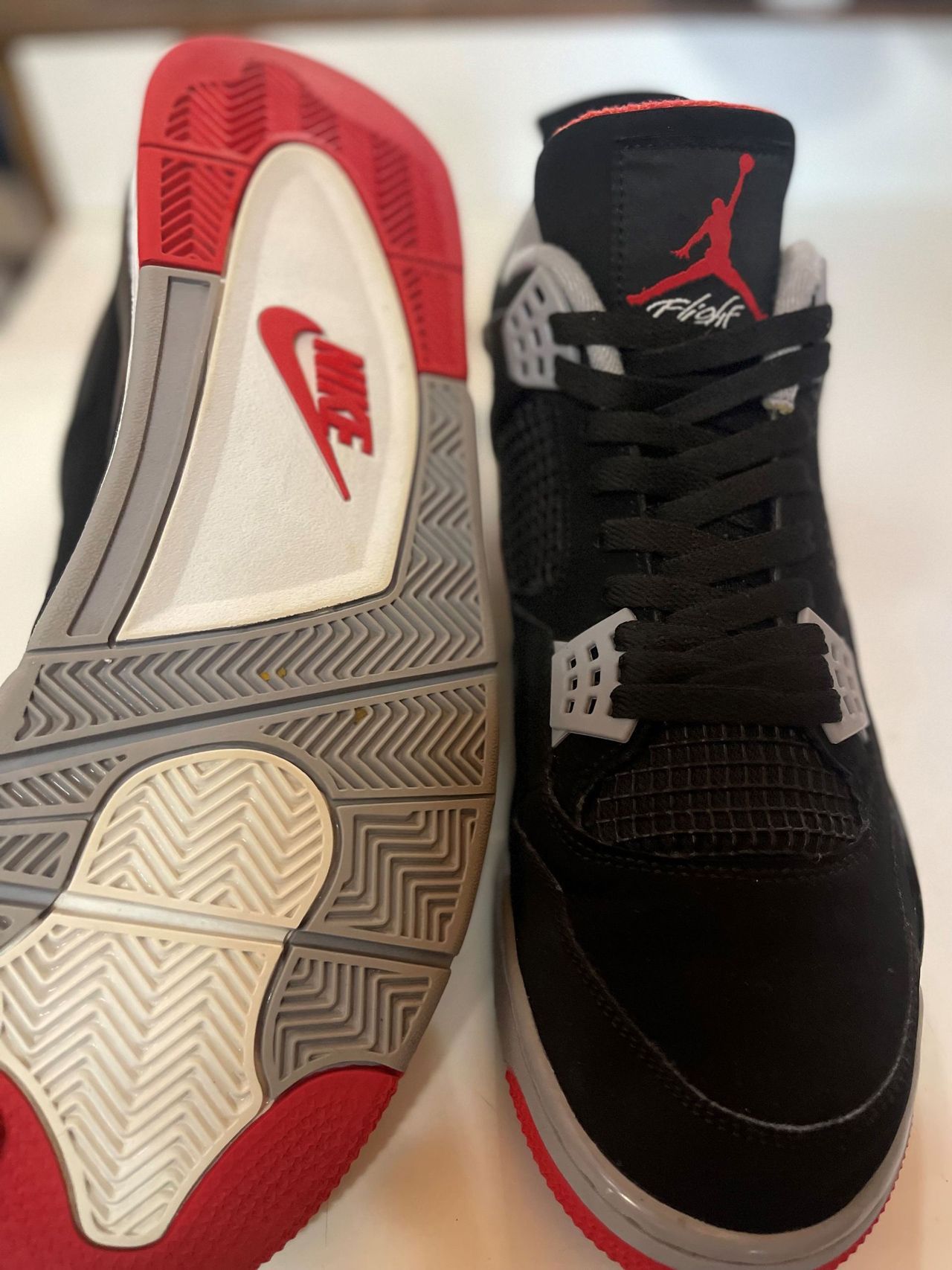 A pair of black and red nike air jordan shoes