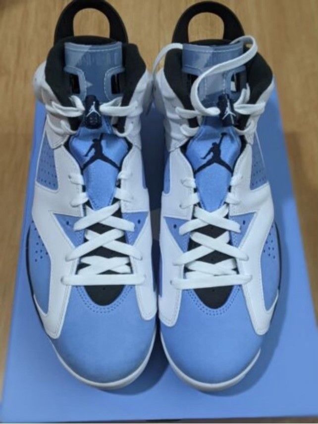 A pair of blue and white basketball shoes on a blue box