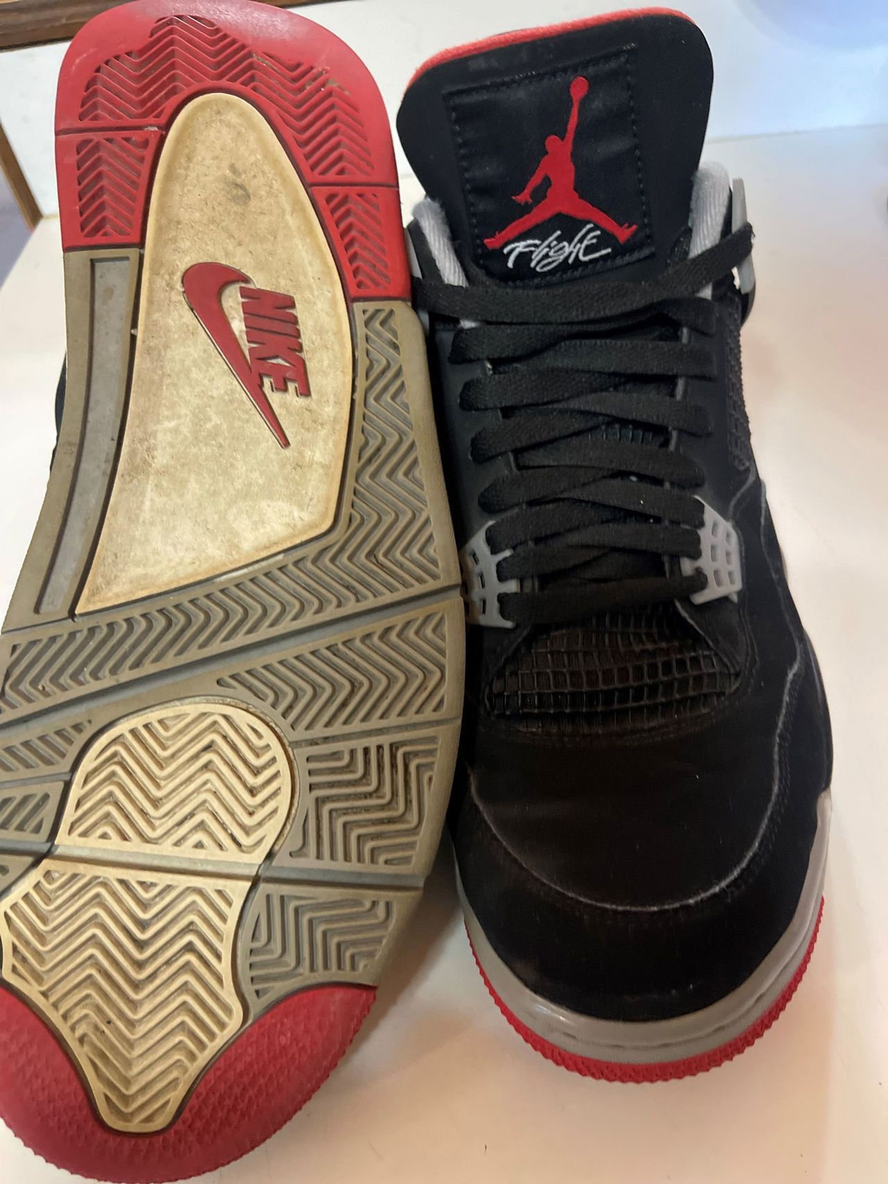 A pair of black and red nike shoes on a table