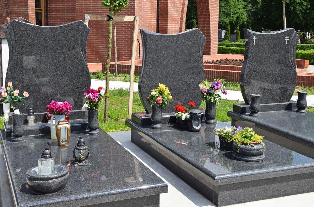Three Graves In A Cemetery With Flowers And Candles — Northern Rivers Headstones in Casino, NSW