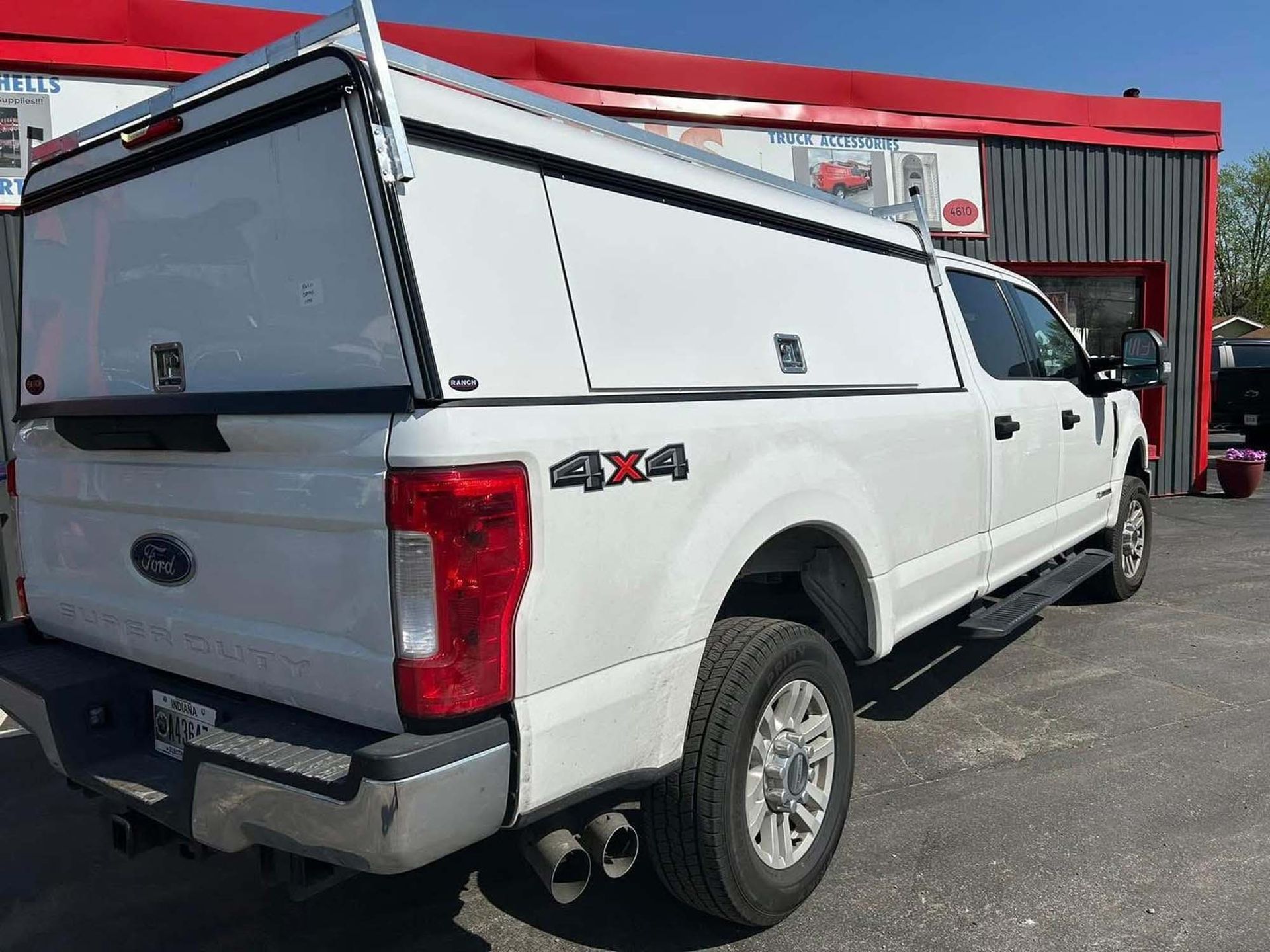 White Ford truck with utility bed
