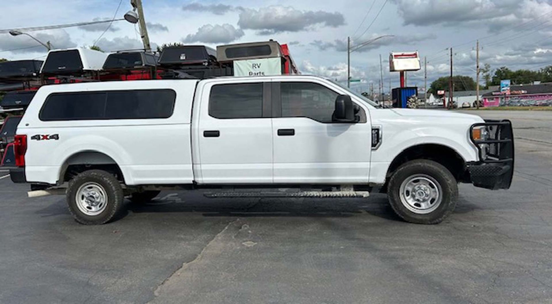 White Ford pickup truck with cap