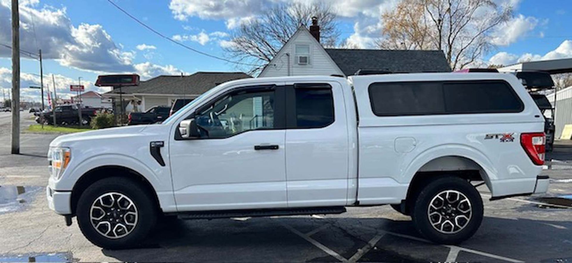 White Ford F-150 truck with cap