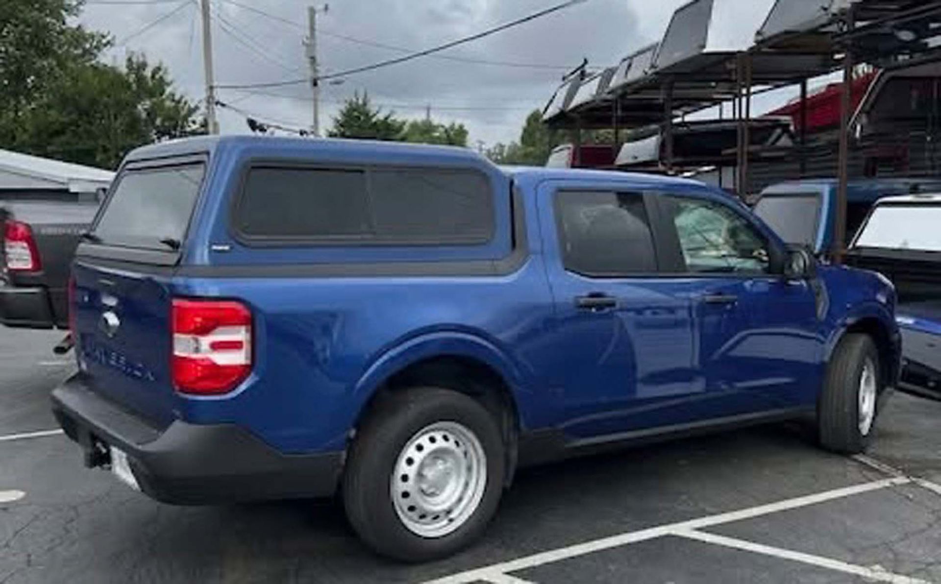 Blue Ford Maverick with camper shell