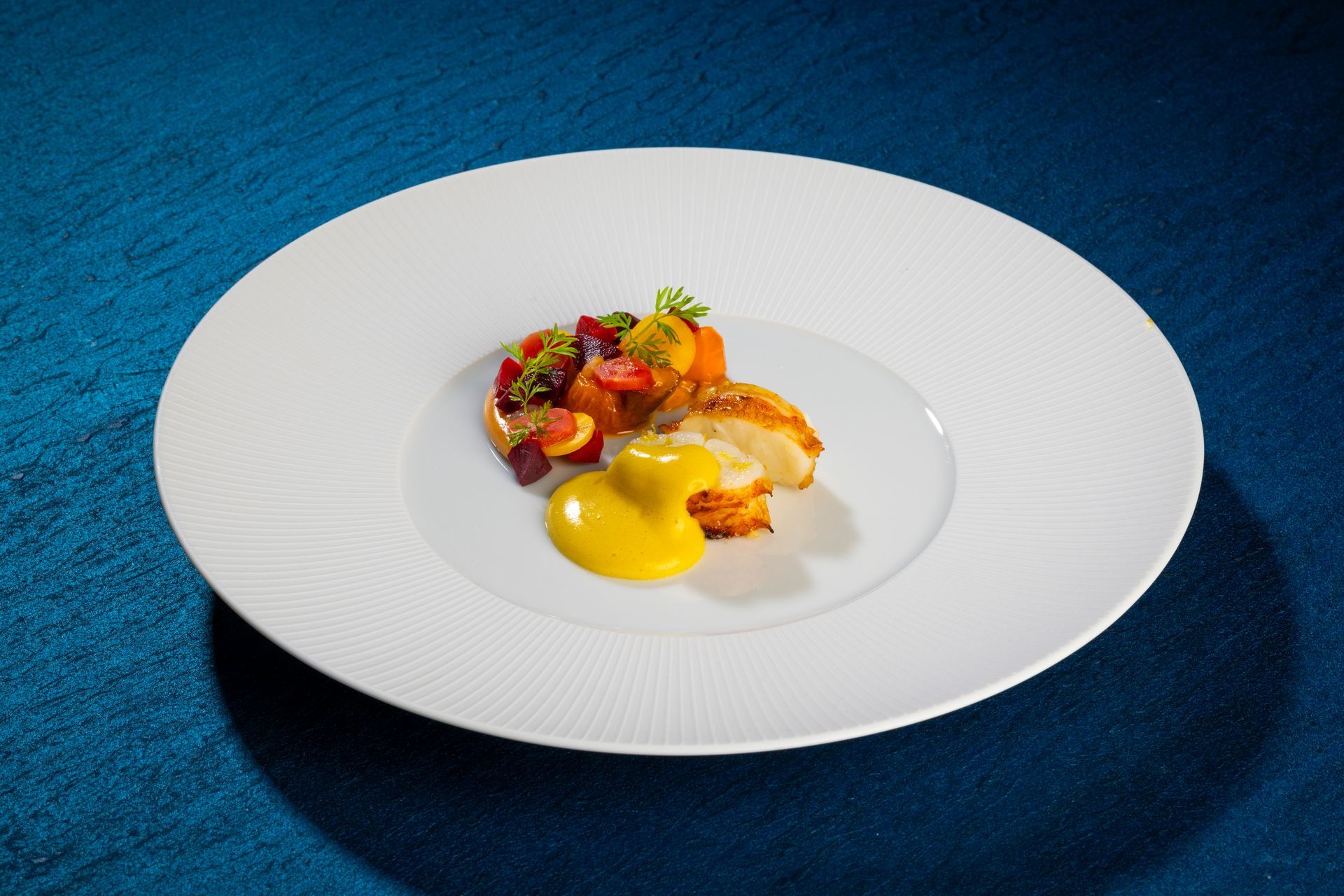 A bone spine with a dish of colorful food on a white plate.