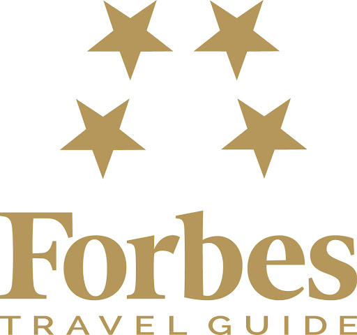Forbes Travel Guide logo with four gold stars above the word