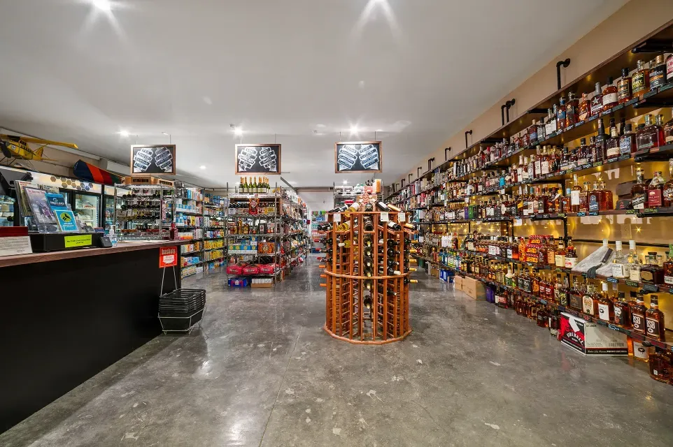A liquor store filled with lots of bottles and shelves.
