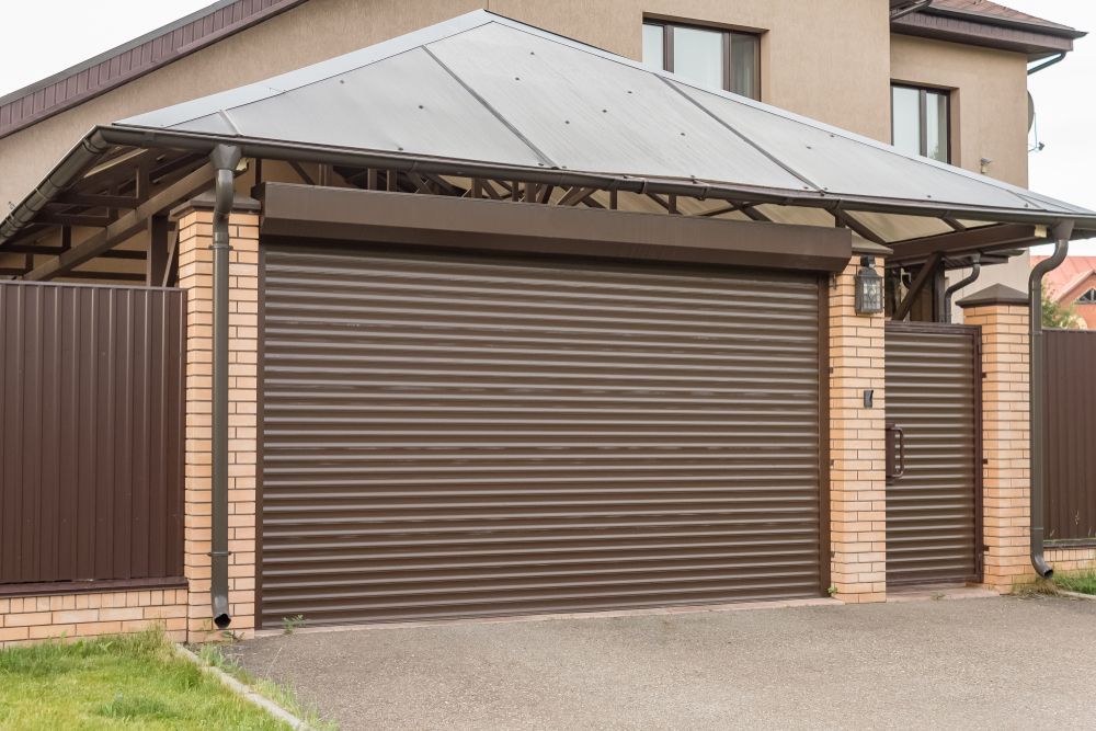 Brown Roller Shutter Garage Door, Closed Position, On A Brick Wall — Ulladulla Blinds & Home Improvements In Ulladulla, NSW
