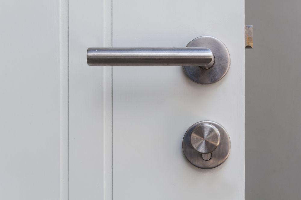 A White Door Handle With A Keyhole — Ulladulla Blinds & Home Improvements In Ulladulla, NSW