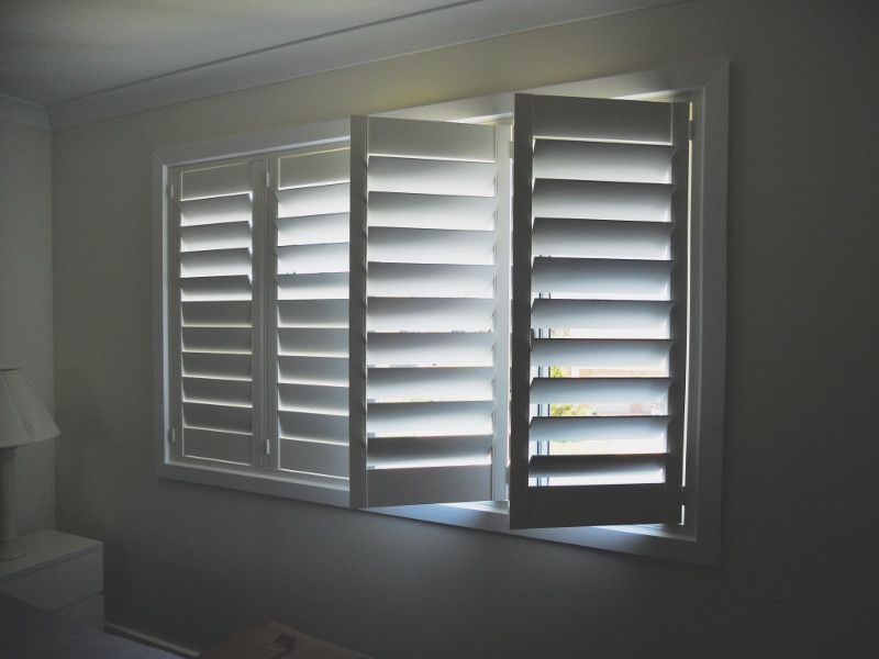 A Window With Shutters Open In A Dark Room — Ulladulla Blinds & Home Improvements In Sussex Inlet, NSW
