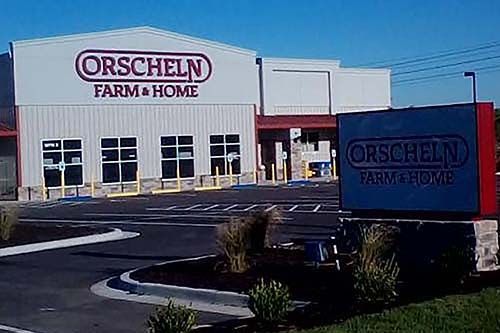 Orscheln Farm & Home store exterior with parking lot and roadside sign on a clear day