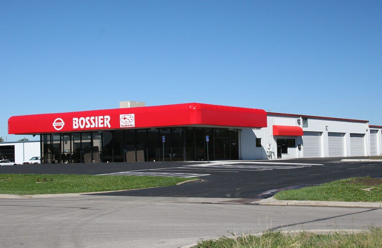 Bossier store with red awning on a sunny roadside corner