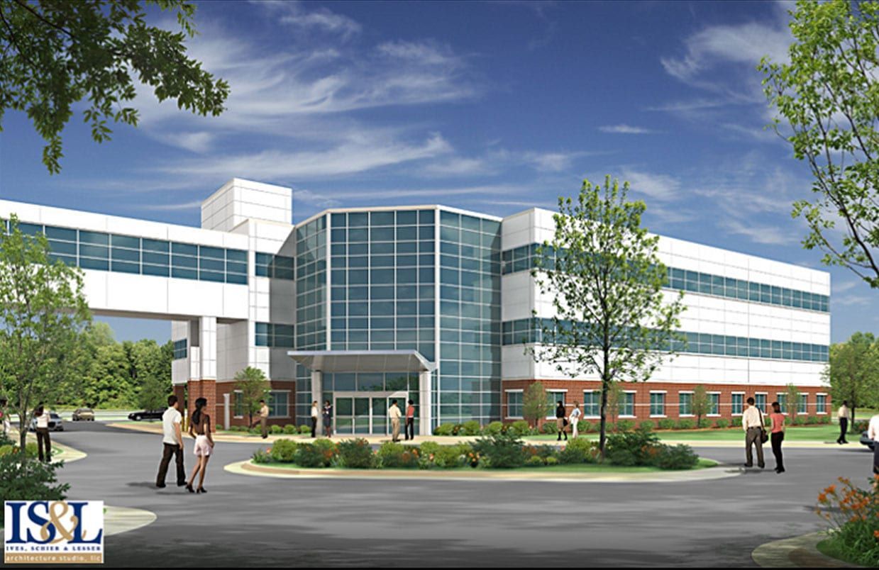 Modern glass office building with people walking outside on a sunny day